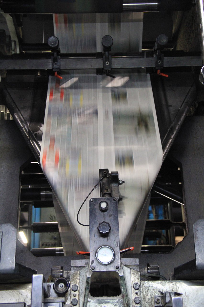 A newspaper running through a Michigan Web Press production line